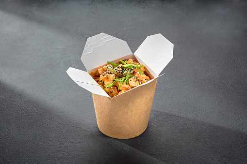 Rice glass noodles with chicken fillet in a wok box, a convenient option for an Asian-inspired quick bite.