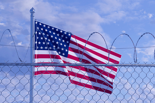 USA border with barbed wire and American Flag