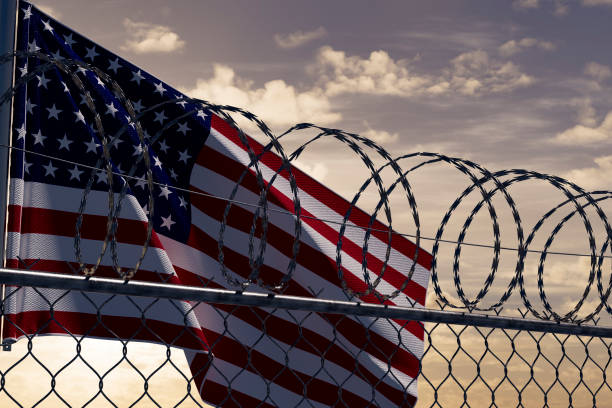 istock USA border with barbed wire and American Flag 2002068664
