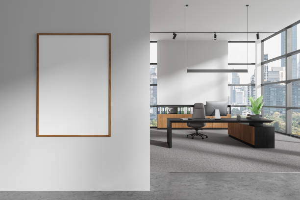 istock White ceo interior desk with pc desktop and sideboard with window. Mockup frame 2002086499