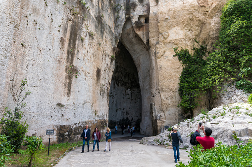 Syracuse, Italy-May 9, 2022:people visit Neapolis, the famous and vast natural park in Syracuse with an ancient Greek theatre, a church, caves and other remains from the Roman era.