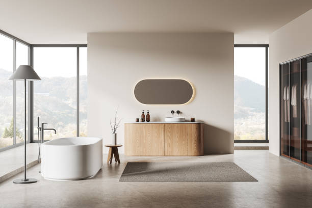 istock Minimalist hotel bathroom interior with bathtub, sink, closet and window 2002092800