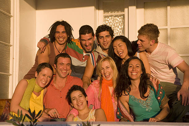 Group of young people on veranda, smiling, portrait stock photo