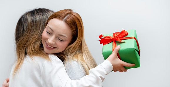 two girls friendship giving gift box