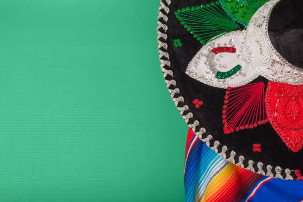 istock Mariachi hat and serape on green background. Mexican independence concept. Cinco de mayo background. 2002123174