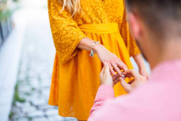 Young man proposing his girlfriend on the street