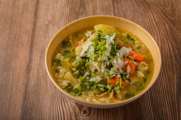 istock Chicken soup with vegetables in a deep bowl on a wooden table. 2002142383