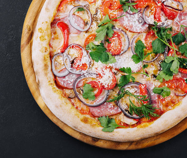 istock Delicious pizza isolated on a black background 2002146840