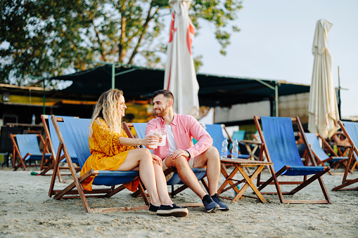 Young couple enjoying in summer days on beach