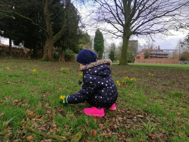 istock Little girl looking the flowers. 2002179996