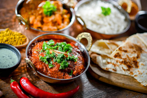 Hot madras paneer and vegetable masala with rice Hot madras paneer and vegetable masala with basmati rice served in original indian karahi pots. karahi stock pictures, royalty-free photos & images