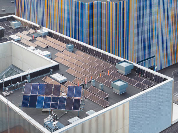 Rooftop with various solar panels Various solar panels on the rooftop of an office building for testing and comparing efficiency. solar panels on the roof of building in a city stock pictures, royalty-free photos & images