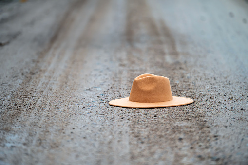 Hat on the road. Selective focus and shallow depth of field.