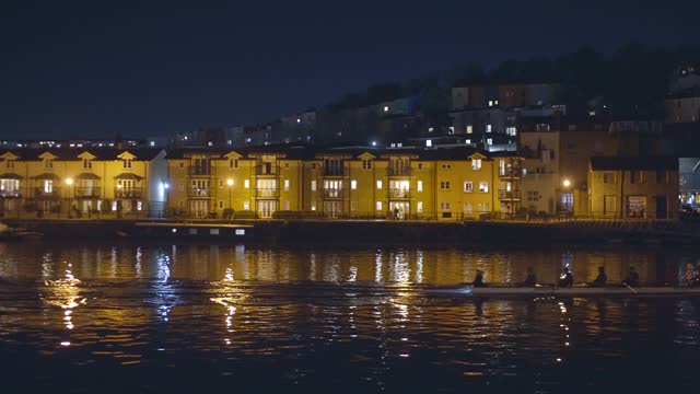 Bristol Harbourside At Night With Pedestrians And Rowers 4K