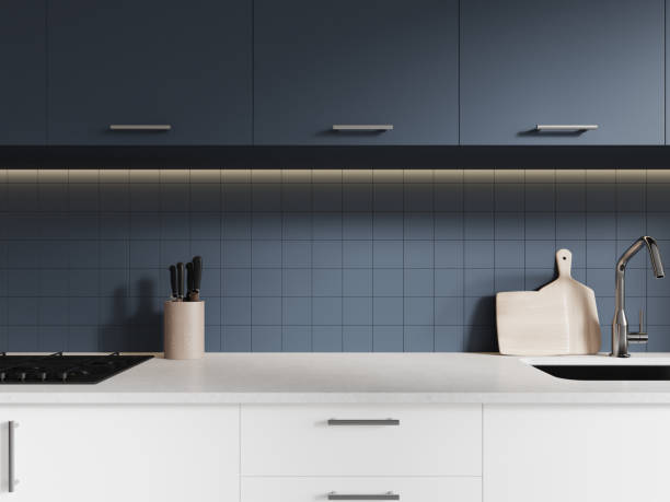 istock Closeup of kitchen interior with stove and sink, blue shelves and kitchenware 2002242317