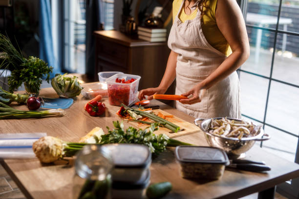 istock Homemaker peeling a carrot when preserving veggies for the winter 2002244967