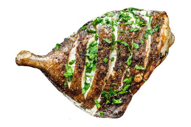 Photo of Grilled John Dory fish with lime and parsley Isolated on white background. Top view.