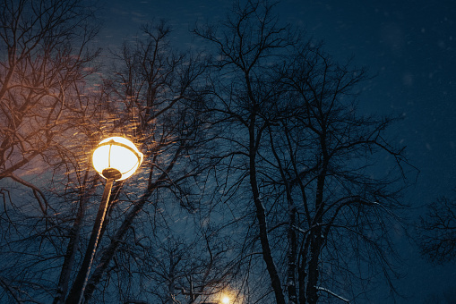 Lamppost with yellow light at dusk
