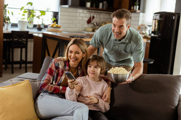 Family Movie Night: Engrossed in Thrilling Scenes at Home