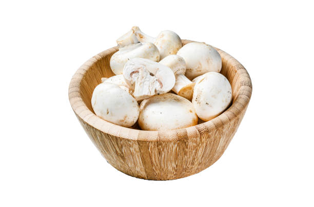 istock Raw white mushrooms in a bamboo bowl.   Isolated on white background. Top view. 2002293478