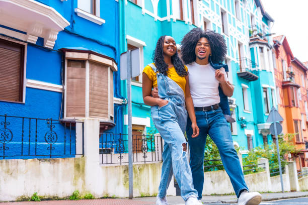 istock Cool african couple strolling along a colorful street 2002301941