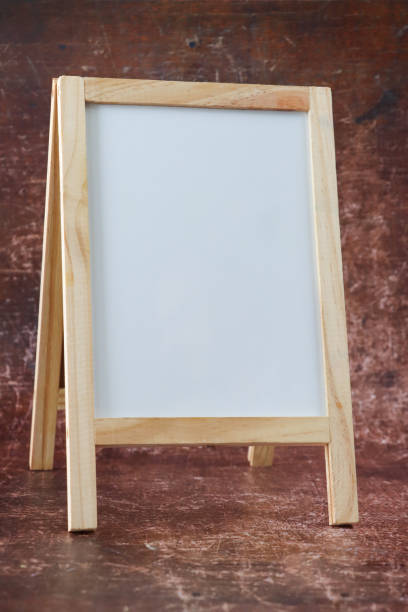 golden wood picture frame with white cut out canvas on easel in art gallery hall