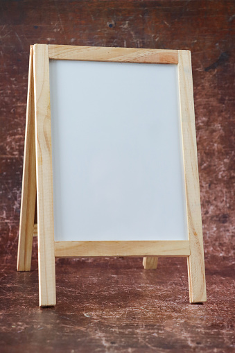 Stock photo showing close-up view of blank, A-frame whiteboard with a glossy, white reusable writing surface for erasable ink markers.