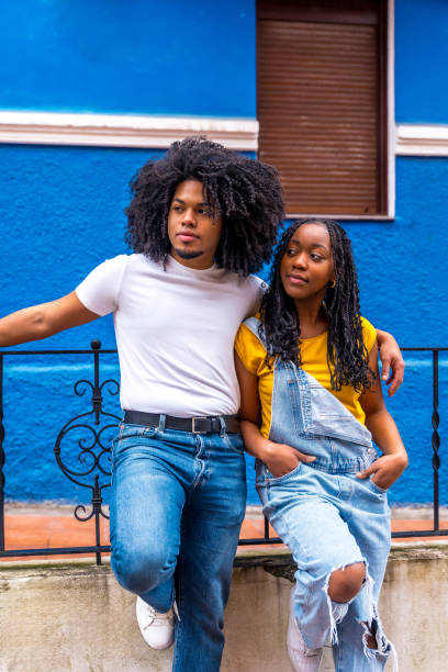 istock Cool african couple embracing from the shoulder leaning on railing 2002336019