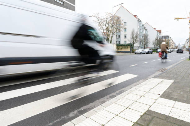 cyclists in motion blur overtaken by van - overtaken imagens e fotografias de stock