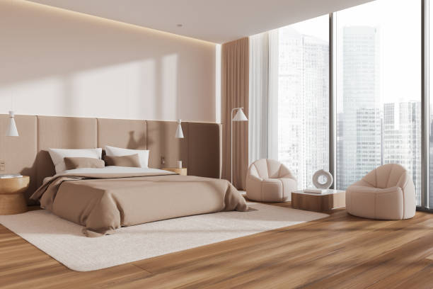 istock Stylish home bedroom interior with bed and two armchairs, panoramic window 2002360535