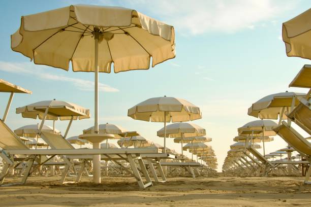 istock Beach umbrellas and sunbeds against clear sky 2002360797