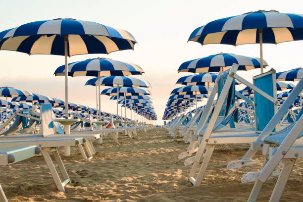 istock Beach umbrellas and sunbeds against clear sky 2002361267