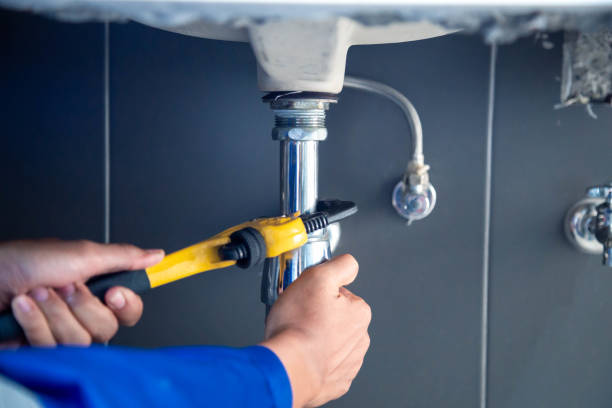 istock Plumber fixing white sink pipe with adjustable wrench. 2002361293