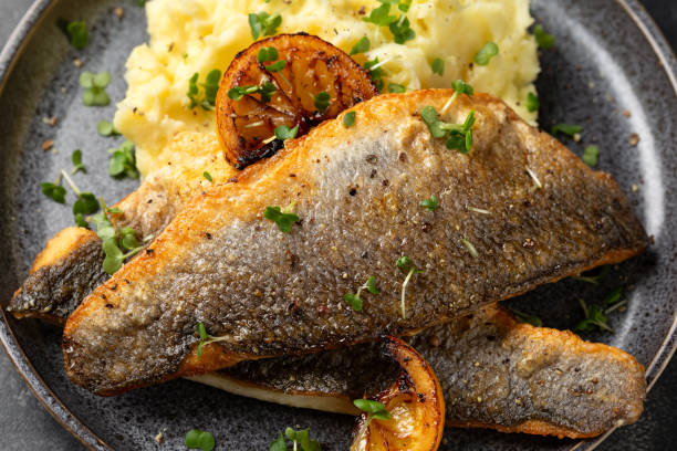 istock Pan fried sea bass fillets served with mashed potatoes and caramelised lemon 2002361771