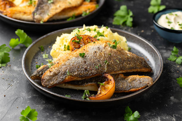 istock Pan fried sea bass fillets served with mashed potatoes and caramelised lemon 2002361783