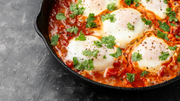 istock Healthy shakshuka with vegetables, herbs, tomatoes in iron cast pan 2002362035
