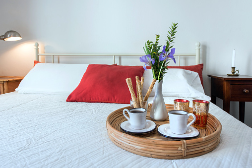 2 cups of coffee, served on a tray in a hotel bedroom