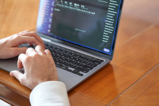 istock Close up of male executive working on laptop with copy space 2002463817
