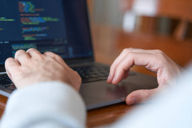 istock Close up of male hands coding on laptop with copy space 2002463819
