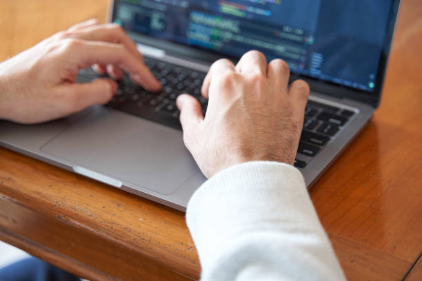 istock Close up of male hands coding in laptop 2002463829