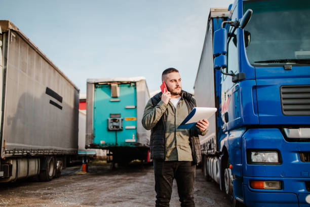 istock Professional truck driver in front on his truck 2002473404