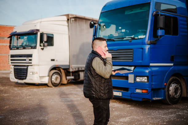 istock Professional truck driver in front on his truck 2002474482