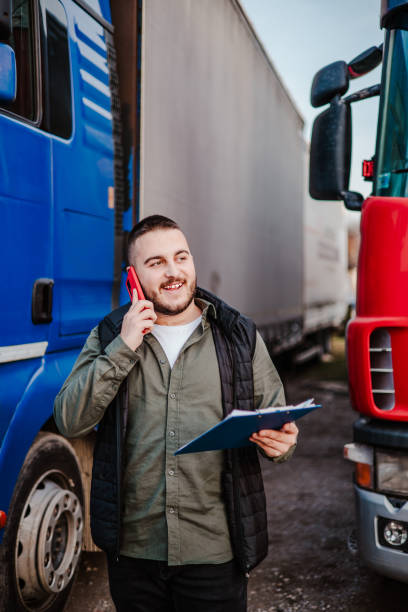 istock Professional truck driver in front on his truck 2002474484
