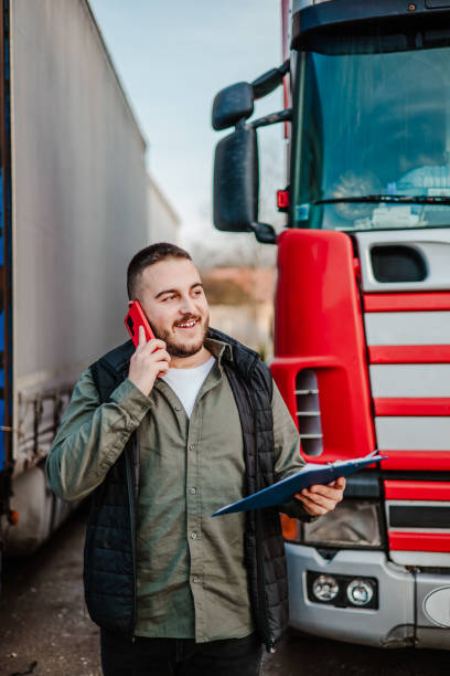 istock Professional truck driver in front on his truck 2002475022