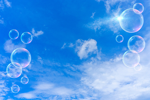 Background material of refreshing blue sky, clouds and sparkling soap bubbles