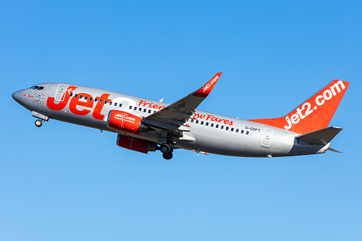Salzburg, Austria - January 27, 2024: Low Cost airline Jet2 in the air. Boeing 737-700 departing into blue sky.
