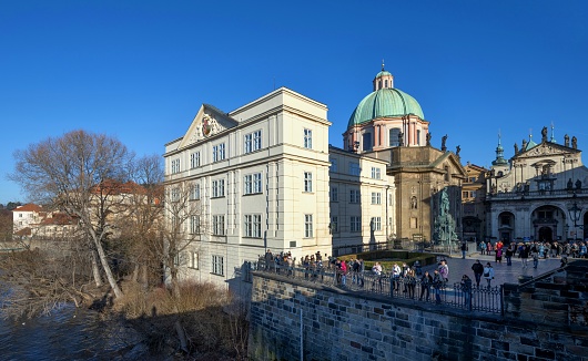 Prague, Czech Republic, January 28, 2024: View of the Charles Bridge Museum and the Church of St. Francis of Assisi in Prague on a sunny afternoon.