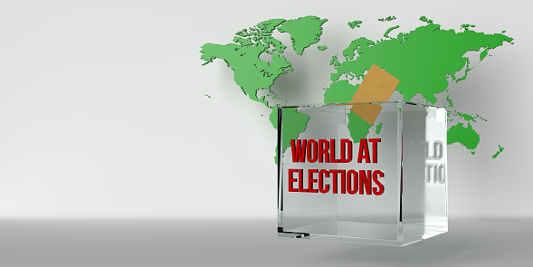 A transparent ballot box in front of a map of the world and a vote cast in it.\nOn the ballot box it says world at elections.\n2024 is a year in which elections almost all over the world coincide with the same year. This year, billions of people will go to the polls and vote for democracy.