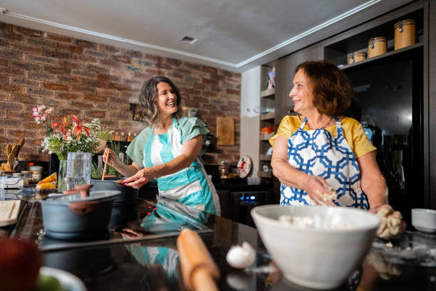 istock Mother and daughter talking and cooking at home 2002517874
