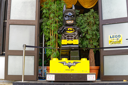 Statue of Lego Batman outside of building with Lego exhibition at City of Bled on a cloudy summer day. Photo taken August 8th, 2023, Bled, Slovenia.